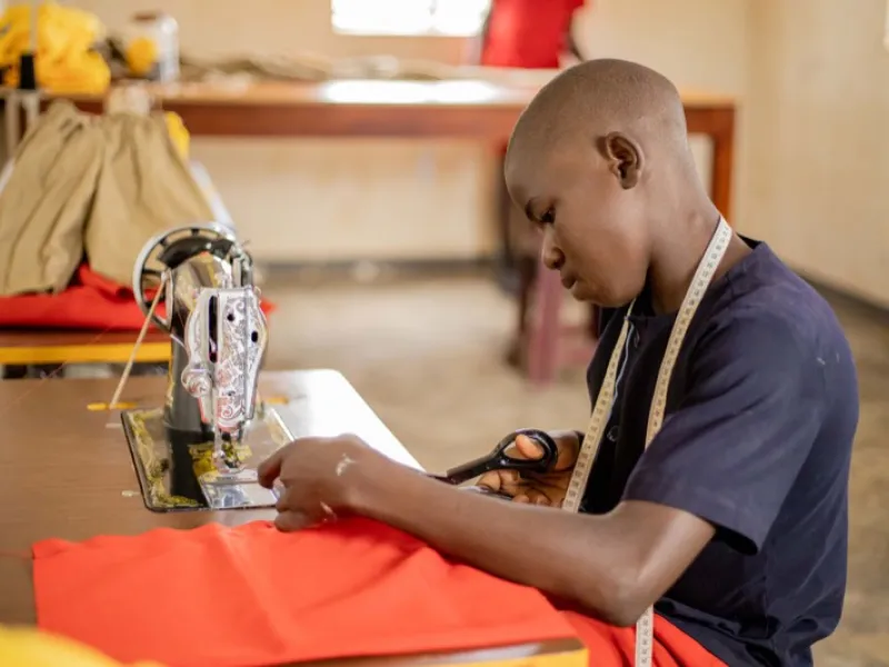 A young man learning tailoring at Amagara Masya centre
